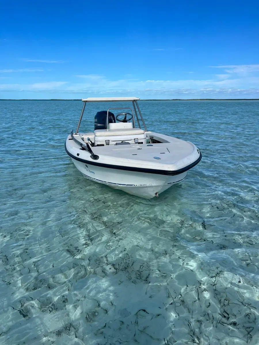 Front view of the Exuma Fly skiff in clear shallow water