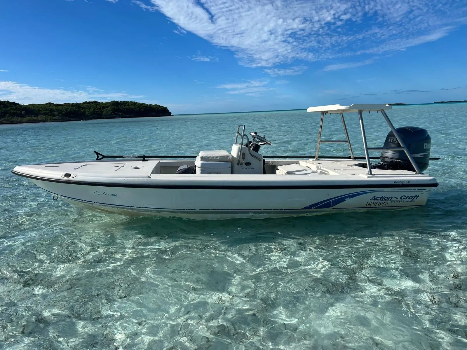 Exuma Fly skiff floating in clear shallow water